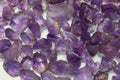 A collection of rough purple amethyst stones intended for faceting.